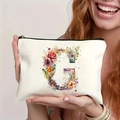 Detailed view of floral letter G printed on a white canvas makeup pouch with black zipper - Letter G (TSND27-7) / 21.5x15cm