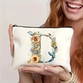 Floral letter D canvas makeup bag shown by a smiling woman in a lifestyle setting - Letter D (TSND27-4) / 21.5x15cm