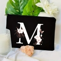 Detail of a black floral makeup bag with letter M print and gold zipper on a floral background - 21.5x15cm / Letter M (TSND30-M)