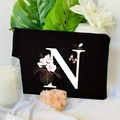 Detail of black floral letter N makeup bag on white fabric with aromatic candle and leaves - 21.5x15cm / Letter N (TSND30-N)