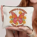 White canvas makeup bag with vintage butterfly and daisy print, features Positive Energy text - Retro Butterfly Yellow Daisy Style (TSND59-6)