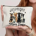 Close-up of white canvas makeup bag featuring cute dog prints and Less People More Dogs text - Five Different Dog Breeds (TSND60-8)