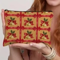 Christmas theme linen zipper makeup bag with red bow and gold bell patterns held by hand - Bells and Bows Style (TSND66-3)
