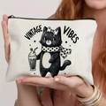 Close-up of vintage cat print on cream canvas zipper pouch held by a model - Vintage Cat (TSND71-19) / 21.5x15cm