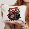 White canvas makeup bag with butterfly and roses, featuring damaged but can still fly text - Butterfly Rose Art Illustration Style (TSND59-14)