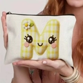 White canvas storage bag featuring a large yellow checkered letter M with a smiley face - 21.5x15cm