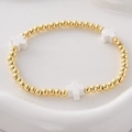 Pulsera de cuentas bañada en oro con cruces de cerámica blanca y cordón elástico - Cruz Blanca