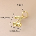 Macro detail of gold-plated copper cherry pendant with dimensions 1.1cm and zircon inlay - Real Gold Plated / Gold Cherry (NAK10-1)