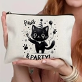 Off-white canvas pouch with black cat party print and Paws & PARTY text held by a model - Party Cat (TSND71-14) / 21.5x15cm