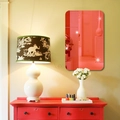 Detail of red acrylic mirror wall sticker with rounded corners in a warm home interior decor - Red