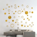 Modern gold acrylic mirror circle wall stickers displayed on a living room wall - Gold