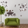 Detailed view of DIY acrylic star and moon mirror wall stickers on a white living room wall - Brown