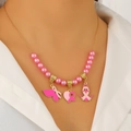 Détail du collier de sensibilisation au cancer du sein avec breloques cœur et ancre - Collier en Émail Perle Rose (9098)