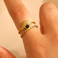 Golden sunburst ring with black gemstone and twisted band detail on finger - 18k Gold Plated (1148)