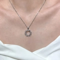 Silver olive leaf necklace with sparkling zircons worn on model's neckline - Silver (WG-0961)