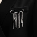 Close-up of silver tassel brooch with hanging chains and crystals on a black suit - White K 6994 (Tassel Cone)