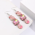 Close-up of Valentine earrings with love heart and pink car pendants on white stand - Love and Car (10754)