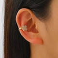 Golden four-leaf clover ear cuff with micro-pave cubic zirconia on a female model - Four Leaf Clover Style (A-166) / Gold