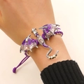 Detail shot of hand-woven purple rope bracelet featuring a silver enamel dragon with crystals - Woven Bracelet (H-106) / Violet