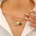 Close-up of golden necklace featuring heart, cross, and portrait medal charms - Portrait Medal Necklace (0156) / KC Gold