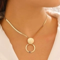 Elegant gold geometric pendant necklace with snake chain shown on a model neck - Brushed Disc Double Circle Necklace (7247)