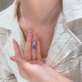 Close-up of a silver starfish necklace with blue sparkling inlay worn by a model - Blue Starfish Style (01 White K N-818)