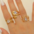 Gold plated stainless steel rings set with zircon stones shown on a model hand - Design Rings Set of 3 Combination 20