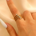 Set of four slim gold stainless steel rings with clear zircon stones for women - Four-layer Thin Ring Round Zircon Staggered Style (12286)