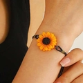 Daisy charm bracelet with yellow sunflower resin pendant and black woven cord strap - Sunflower Woven Rope Bracelet (11795) / Antique Bronze