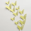 Detailed macro view of 3D light yellow laser-cut butterfly wall stickers on white backdrop - Verdant