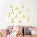 Detailansicht von 12 goldenen Eiffelturm Spiegel-Wandstickern in moderner Wohnzimmer-Deko - Gold