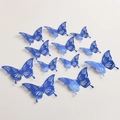 Lot de 12 papillons muraux 3D bleus avec motifs floraux creux au fini métallique - Style E / Bleu