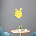 Detailed view of yellow bunny mirror wall sticker on minimalist grey wall with home decor - Gold