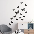Detailed view of 3D black acrylic mirror butterfly wall stickers in a modern living room - Black