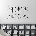 Detailed view of 6 black acrylic ballet dancer silhouettes on a white living room wall - Black