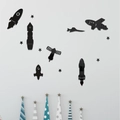 Macro detail of black acrylic space-themed wall stickers with rocket and satellite motifs - Black