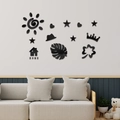 Macro detail of 3D acrylic home wall stickers including sun, heart and star shapes - Black