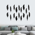 Detail view of 18-piece black acrylic feather mirror wall stickers in a modern living room - Black