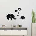 Detail view of black acrylic elephant and heart mirror wall stickers on a white wall - Black (JM603)