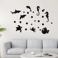 Detailed close-up of 3D black acrylic ocean creature wall stickers in a modern living room - Black