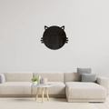 Detail of cat shaped acrylic mirror wall sticker above a modern sofa in a living room - Black