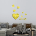Golden acrylic mirror wall stickers with heart and key design above a sofa - Gold (JM3153)