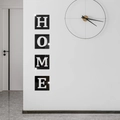 Detail showing 3D acrylic mirror wall stickers forming the word HOME on a white wall - Black