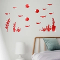 Detail of red acrylic mirror wall stickers with marine life patterns on a bedroom wall - Red