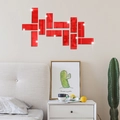 Detail of red acrylic mirror wall stickers showing reflective finish in a modern bedroom - Red