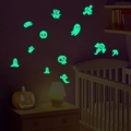 Luminous Halloween wall stickers featuring green glowing ghosts and skulls in bedroom - Green