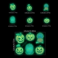 Detail showing dimensions of glowing Halloween wall stickers with green pumpkin designs - Green