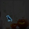 Luminous Halloween crow wall decals with blue neon glow effect on dark window backdrop - Blue