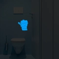 Luminous bathroom wall sticker featuring a smiling toilet paper roll in bright blue glow - Blue