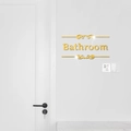 Dettaglio dell'adesivo a specchio dorato per bagno con eleganti volute decorative - Oro